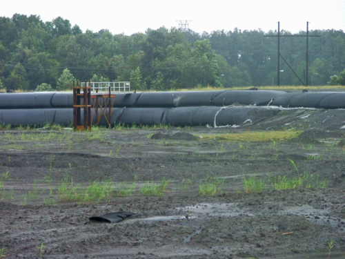 Completed, stacked geotextile tube installation with weir structure